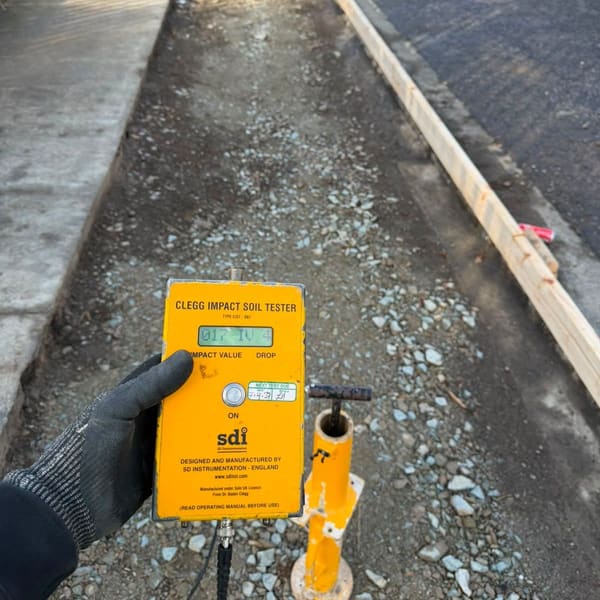 A Clegg impact tester reading taken on the compacted sub-base inside the formwork.